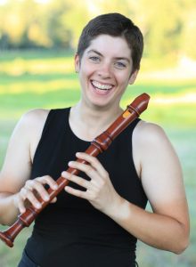 Emily O'Brien holding a clarinet and smiling