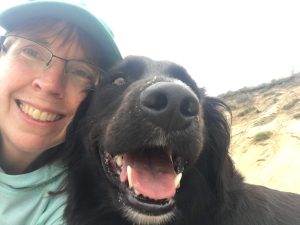 Luanne Stiles with her dog Nelson, both smiling